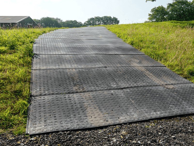 Indoor vs Outdoor Industrial Mats An indoor anti-fatigue mat next to a rugged outdoor ground protection mat