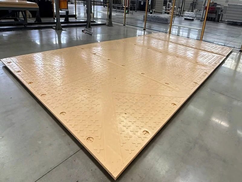 Forklift handling a large-format heavy-duty composite access mat